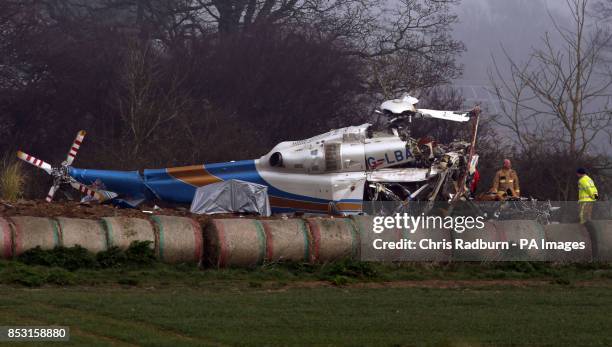 The wreckage of a helicopter alongside the A146 after four people have died when a helicopter came down in thick fog in a field in Gillingham, near...