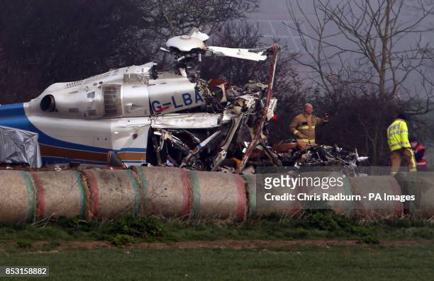 The wreckage of a helicopter alongside the A146 after four people have died when a helicopter came down in thick fog in a field in Gillingham, near...
