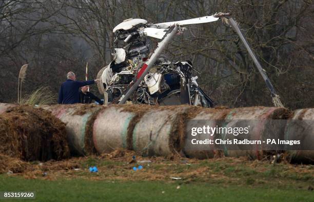 The wreckage of a helicopter alongside the A146 after four people have died when a helicopter came down in thick fog in a field in Gillingham, near...