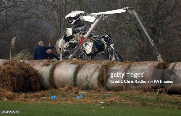 The wreckage of a helicopter alongside the A146 after four people have died when a helicopter came down in thick fog in a field in Gillingham, near...