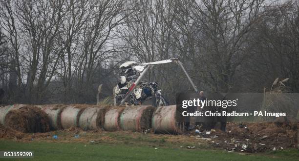 The wreckage of a helicopter alongside the A146 after four people have died when a helicopter came down in thick fog in a field in Gillingham, near...