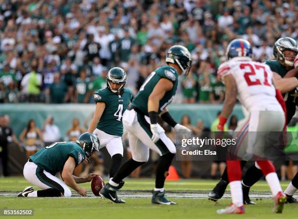 Jake Elliott of the Philadelphia Eagles kicks a 61-yeard field goal to win the game as Donnie Jones holds on September 24, 2017 at Lincoln Financial...