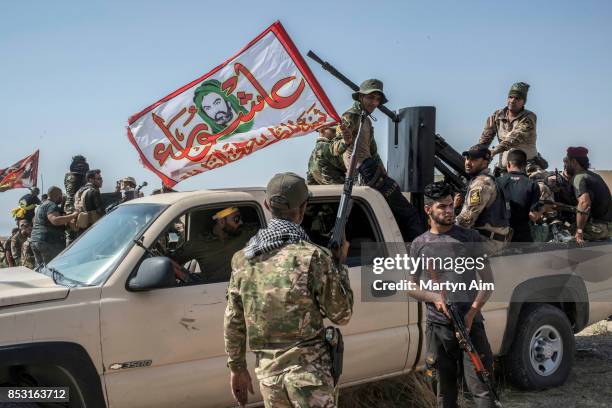 Soldiers of the Hashd Al-Shaabi prepare to fight in an offensive to drive out Islamic State militants on September 24, 2017 in Hawija, Iraq. The...