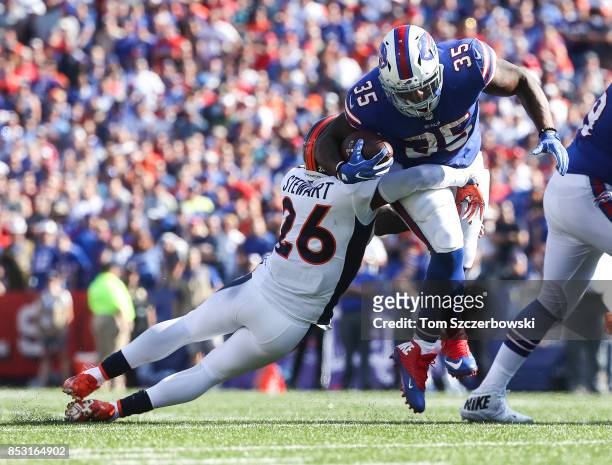 Darian Stewart of the Denver Broncos attempts to tackle Mike Tolbert of the Buffalo Bills during an NFL game on September 24, 2017 at New Era Field...