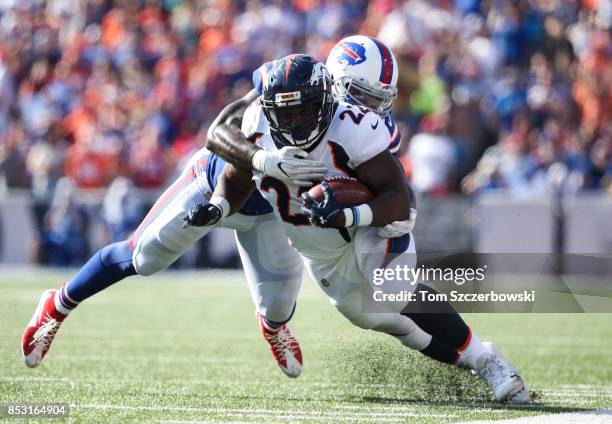 Ramon Humber of the Buffalo Bills attempts to tackle C.J. Anderson of the Denver Broncos during an NFL game on September 24, 2017 at New Era Field in...