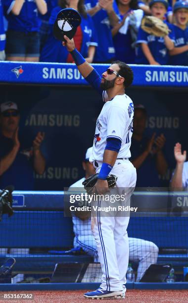 Jose Bautista of the Toronto Blue Jays tips his hat to the fans after he is pulled from the game in the ninth inning during MLB game action against...