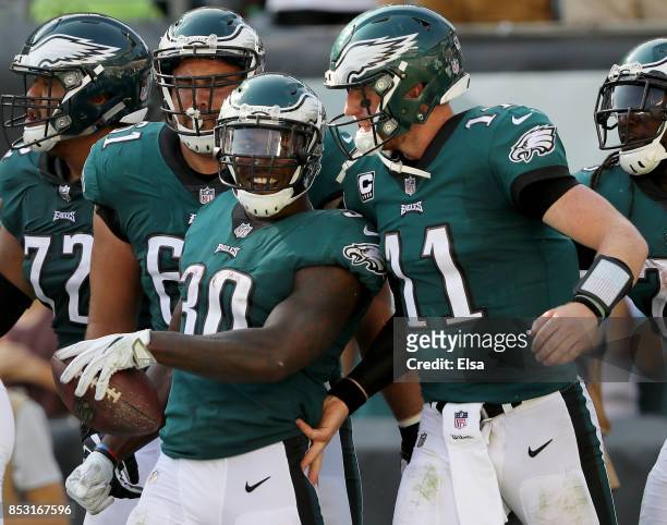 Corey Clement of the Philadelphia Eagles is congratulated by teammate Carson Wentz after Clement scored in the fourth quarter against the New York...