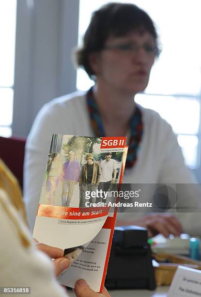 An Unemployed woman reads a brochure at a Federal Work Agency on March 9, 2009 in Berlin, Germany. A recent report by the European Commission is...