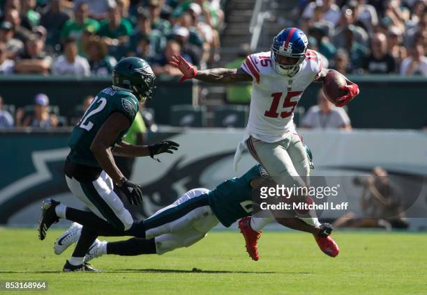 Brandon Marshall of the New York Giants runs with the ball against Patrick Robinson and Rasul Douglas of the Philadelphia Eagles in the third quarter...