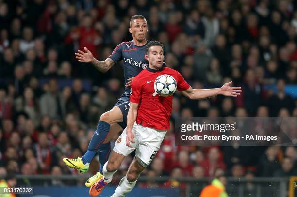 Manchester United's Robin van Persie is fouled by Olympiakos' Jose Holebas to earn his side a penalty
