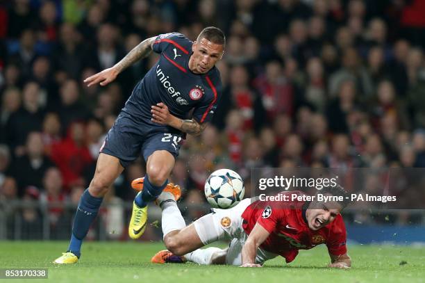 Manchester United's Robin van Persie is fouled by Olympiakos' Jose Holebas to earn his side a penalty