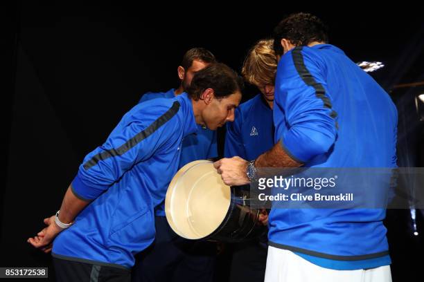 Alexander Zverev, Rafael Nadal, Roger Federer and Marin Cilic of Team Europe look at the trophy after winning the Laver Cup on the final day of the...