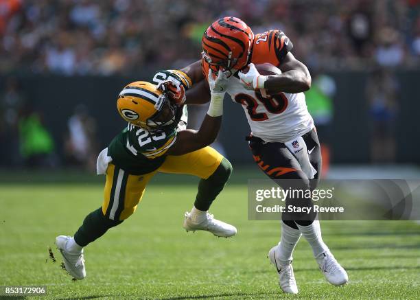 Marwin Evans of the Green Bay Packers grabs the face mask of Joe Mixon of the Cincinnati Bengals trying to make a tackle during the first quarter of...
