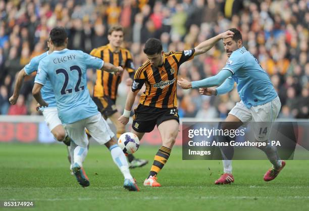 Hull City's Shane Long in action with Manchester City's Gael Clichy and Javier Garcia during the Barclays Premier League match at the KC Stadium,...