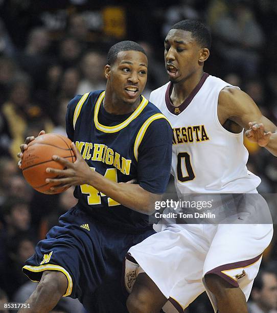 Kelvin Grady of the University of Michigan Wolverines is defended by Al Nolen of the Minnesota Golden Gophers during an NCAA game on March 7, 2009 at...