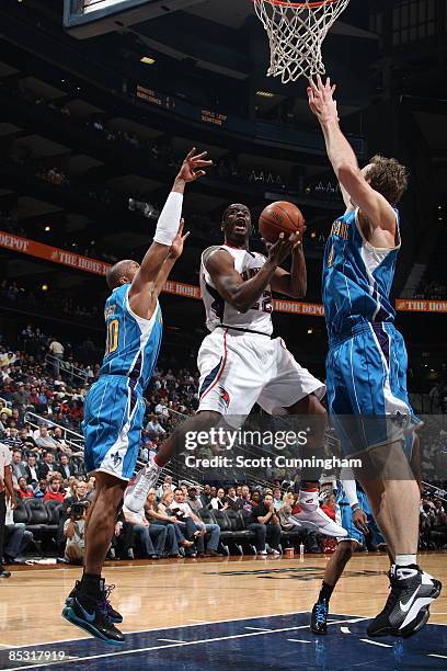 Flip Murray of the Atlanta Hawks goes for a shot against the New Orleans Hornets at Philips Arena on March 9, 2009 in Atlanta, Georgia. NOTE TO USER:...