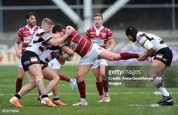 Huddersfield Giants' Brett Ferres is tackled by Bradford Bulls' Danny Addy and Chev Walker during the First Utility Super League match at the Odsal...