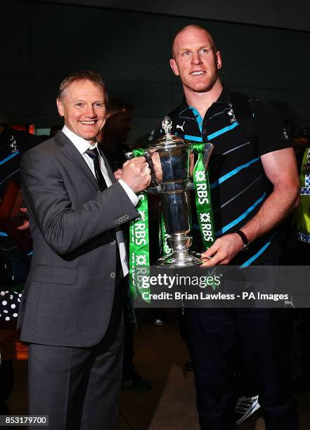 Ireland captain Paul O'Connell and head coach Joe Schmidt with the 6 nations trophy as the Ireland team arrive at Dublin Airport, Ireland.