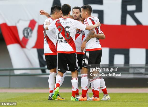 Gonzalo Martinez of River Plate celebrates with teammates Ignacio Scocco, Carlos Auzqui and Ignacio Fernandez after scoring the first goal of his...