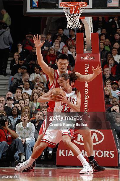 Joakim Noah of the Chicago Bulls drives the ball against Yao Ming of the Houston Rockets during the game at the United Center on February 28, 2009 in...