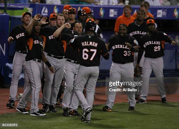 Gregory Halman of The Netherlands celebrates scoring a run against Puerto Rico in the first inning during the 2009 World Baseball Classic Pool D...
