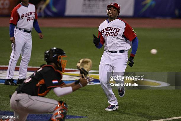 Bernie Williams of Puerto Rico is tagged out at the plate by Kenley Jansen of The Netherlands during the 2009 World Baseball Classic Pool D match on...