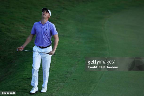 Justin Thomas of the United States reacts to a missed birdie putt on the 18th green on his way to winning the FedExCup and second in the TOUR...