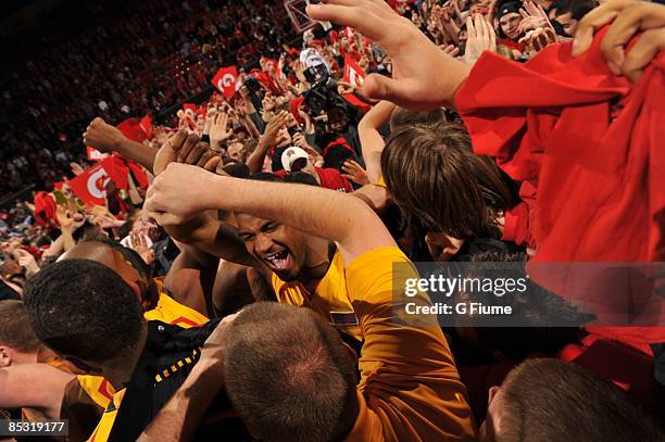 Landon Milbourne of the Maryland Terrapins celebrates with fans after beating the North Carolina Tar Heels 88-85 in overtime at the Comcast Center on...