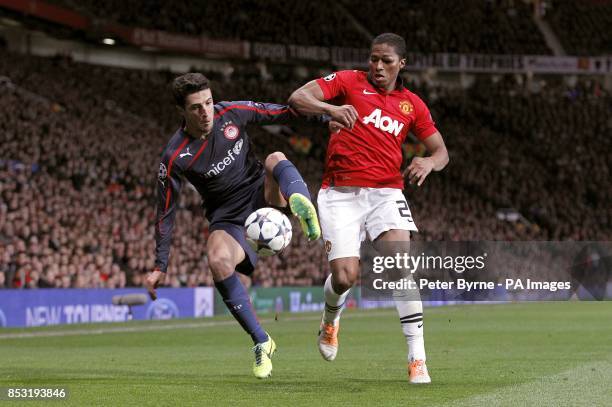 Manchester United's Antonio Valencia and Olympiakos' Ivan Marcano battle for the ball