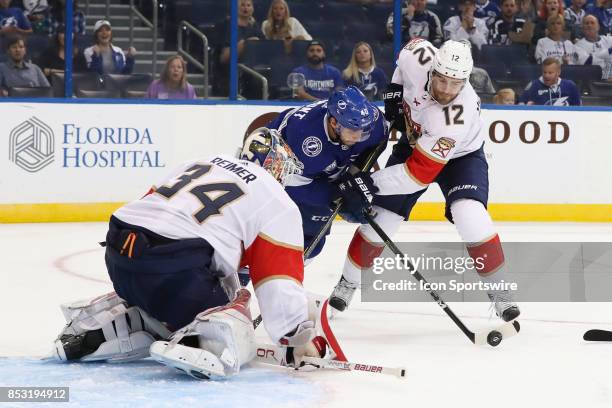 Tampa Bay Lightning center Gabriel Dumont is defended by Florida Panthers defenseman Ian McCoshen as he tries to get a shot on Florida Panthers...
