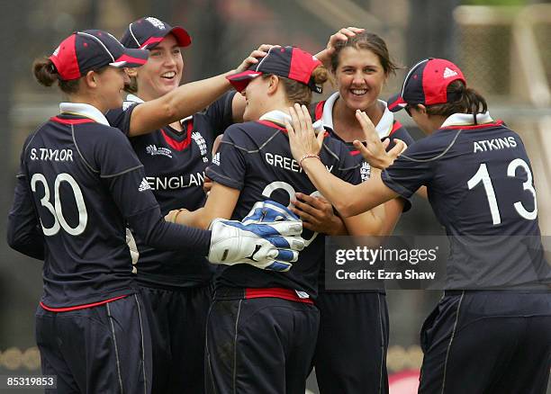 Lydia Greenway of England is congratulated by teammates after catching Mithali Raj of India during the ICC Women's World Cup 2009 round one group...