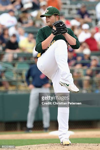 Starting pitcher Brett Anderson of the Oakland Athletics pitches against the Cleveland Indians during the spring training game at Phoenix Municipal...