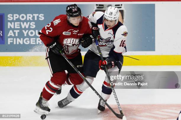 Forward Liam Stevens of the Guelph Storm places a hit against forward Chris Playfair of the Windsor Spitfires on September 24, 2017 at the WFCU...