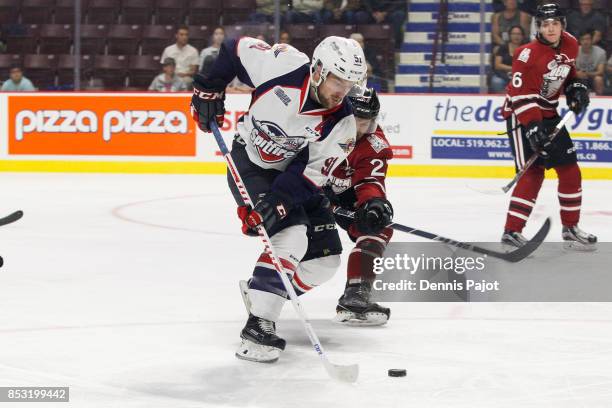 Forward Aaron Luchuk of the Windsor Spitfires moves the puck against the Guelph Storm on September 24, 2017 at the WFCU Centre in Windsor, Ontario,...