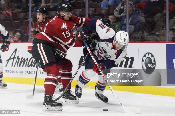 Forward Liam Hawell of the Guelph Storm battles for the puck against forward Aaron Luchuk of the Windsor Spitfires on September 24, 2017 at the WFCU...