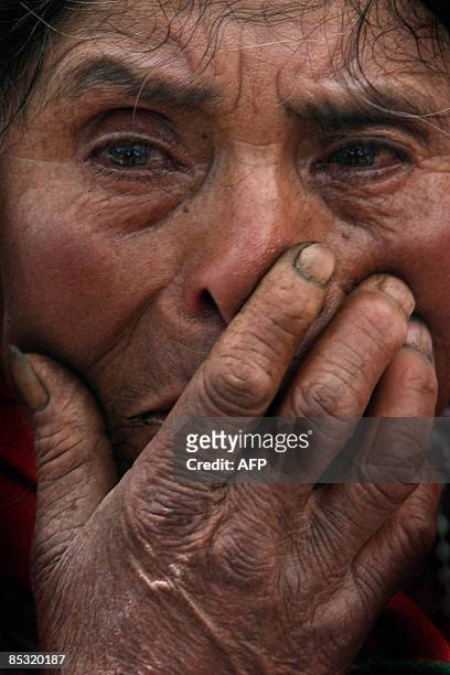 Relative of a victim cries as a forensic team works in a mass grave in the city of Huanta, Ayacucho, Peru, on March 9, 2009. Experts started digging...