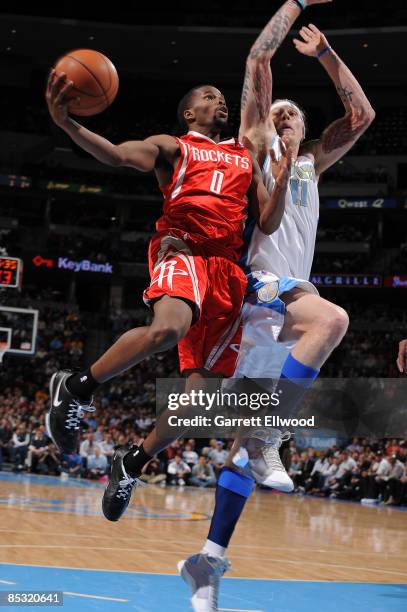 Aaron Brooks of the Houston Rockets goes to the basket against Chris Andersen of the Denver Nuggets on March 9, 2009 at the Pepsi Center in Denver,...