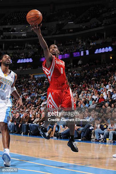 Aaron Brooks of the Houston Rockets goes to the basket against Nene of the Denver Nuggetson March 9, 2009 at the Pepsi Center in Denver, Colorado....