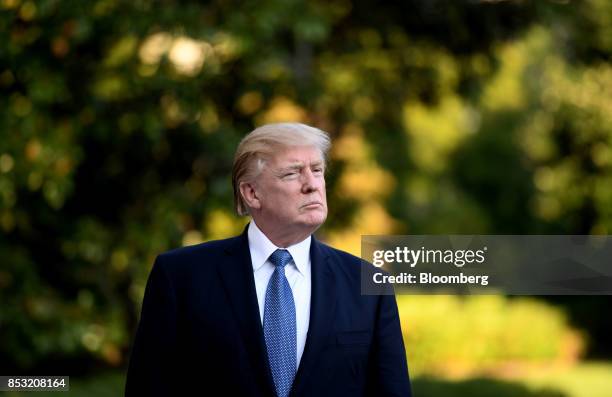 President Donald Trump listens to members of the media on the South Lawn after returning to the White House in Washington, D.C., U.S., on Saturday,...