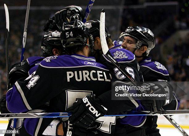 Ted Purcell, Michal Handzus and Alexander Frolov of the Los Angeles Kings celebrate with teammate Jarret Stoll after Stoll's goal in the second...