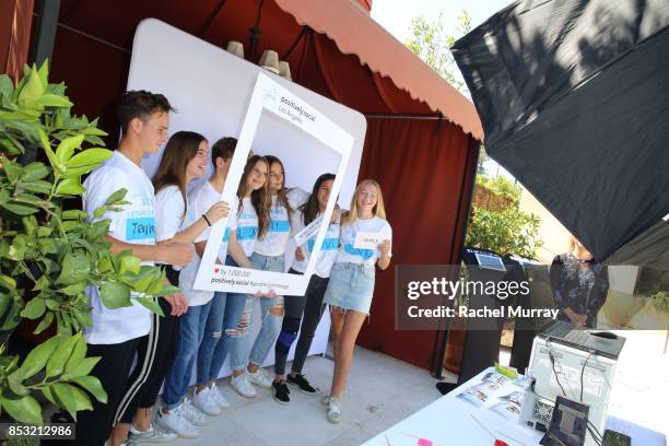 Guests take photos during the Positively Social launch event on September 24, 2017 in Beverly Hills, California.