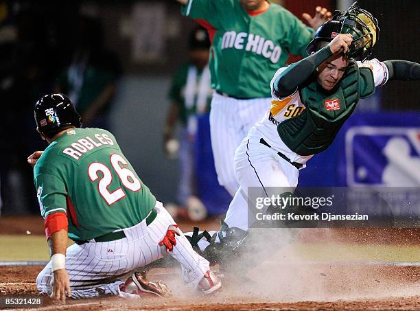 Kyle Botha of South Africa looks for the ball as Oscar Robles of Mexico scores a run on an errant throw from first baseman Brett Willemburg during...