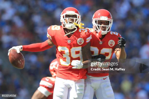 Jacoby Glenn and Marcus Peters of the Kansas City Chiefs celebrate after intercepting the ball during the game against the Los Angeles Chargers at...