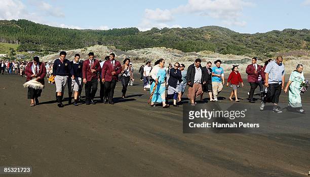 Family and friends walk towards the ocean during a memorial service for missing Warriors NRL player Sonny Fai at Bethells Beach on March 10, 2009 in...