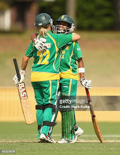 Mignon Du Preez congratulates Trisha Ghetty of South Africa after she scored a half century during the ICC Women's World Cup 2009 round two group...