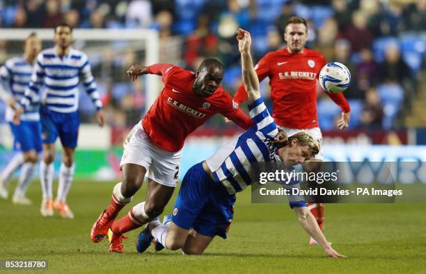 Reading's Pavel Pogrebnyak is challenged by Barnsley's Jean Yves-M'Voto during the Sky Bet Championship match at the Madejski Stadium, Reading.