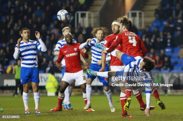 Barnsley's Tom Kennedy clears under pressure from Reading's Adam Le Fondre during the Sky Bet Championship match at the Madejski Stadium, Reading.