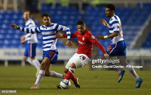 Barnsley's Reuben Noble-Lazarus is challenged by Reading's Jobi McAnuff during the Sky Bet Championship match at the Madejski Stadium, Reading.