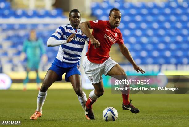 Barnsley's Chris O'Grady gets away from Reading's Hope Akpan during the Sky Bet Championship match at the Madejski Stadium, Reading.