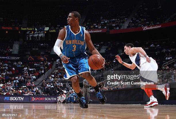 Chris Paul of the New Orleans Hornets brings the ball up against Mike Bibby of the Atlanta Hawks at Philips Arena on March 9, 2009 in Atlanta,...